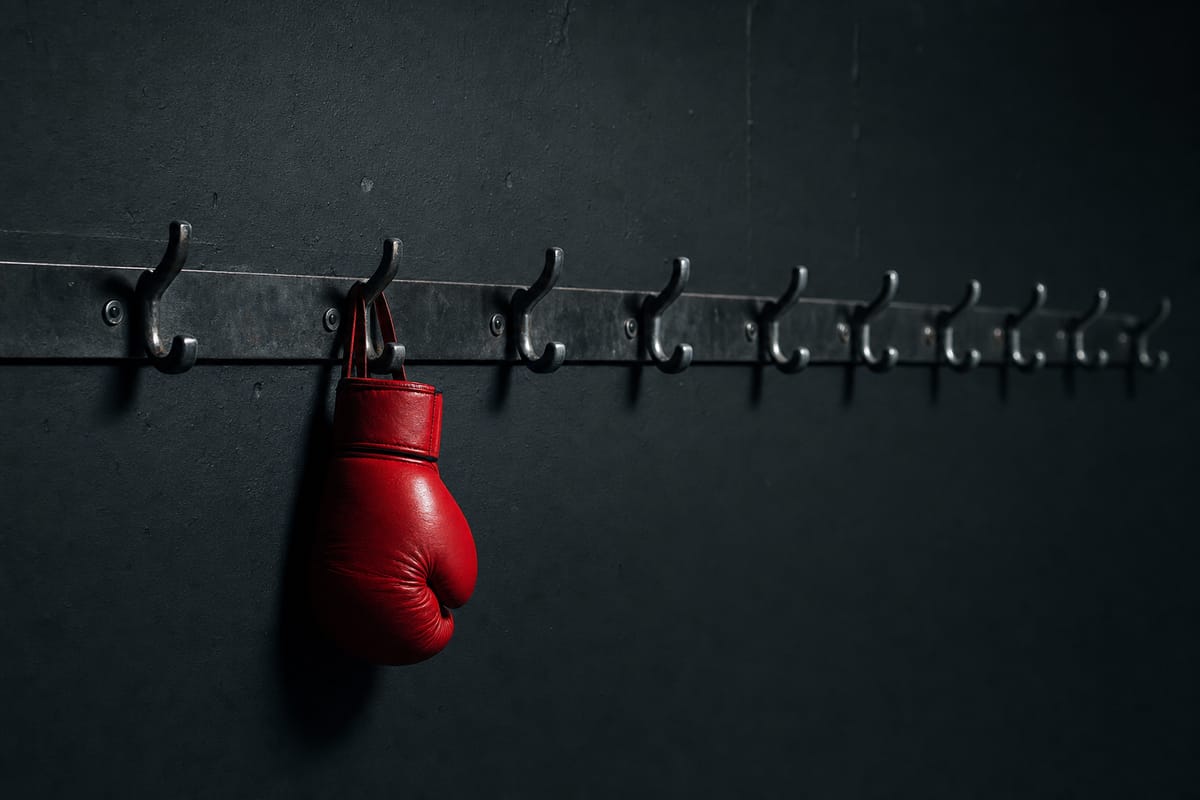 A row of ten steel hooks on a dark gym wall, one hook holding a red glove (AI-generated image)