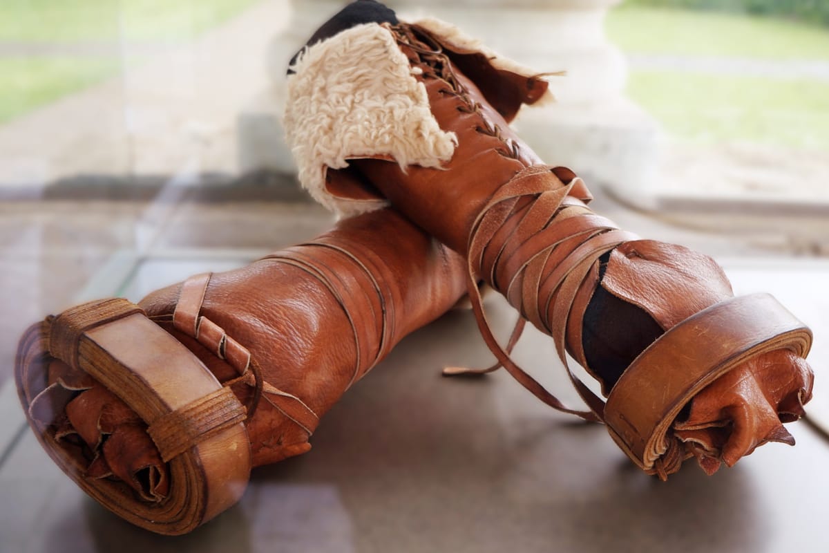 Reconstruction of ancient leather hand wraps with a fleece cuff displayed in a museum